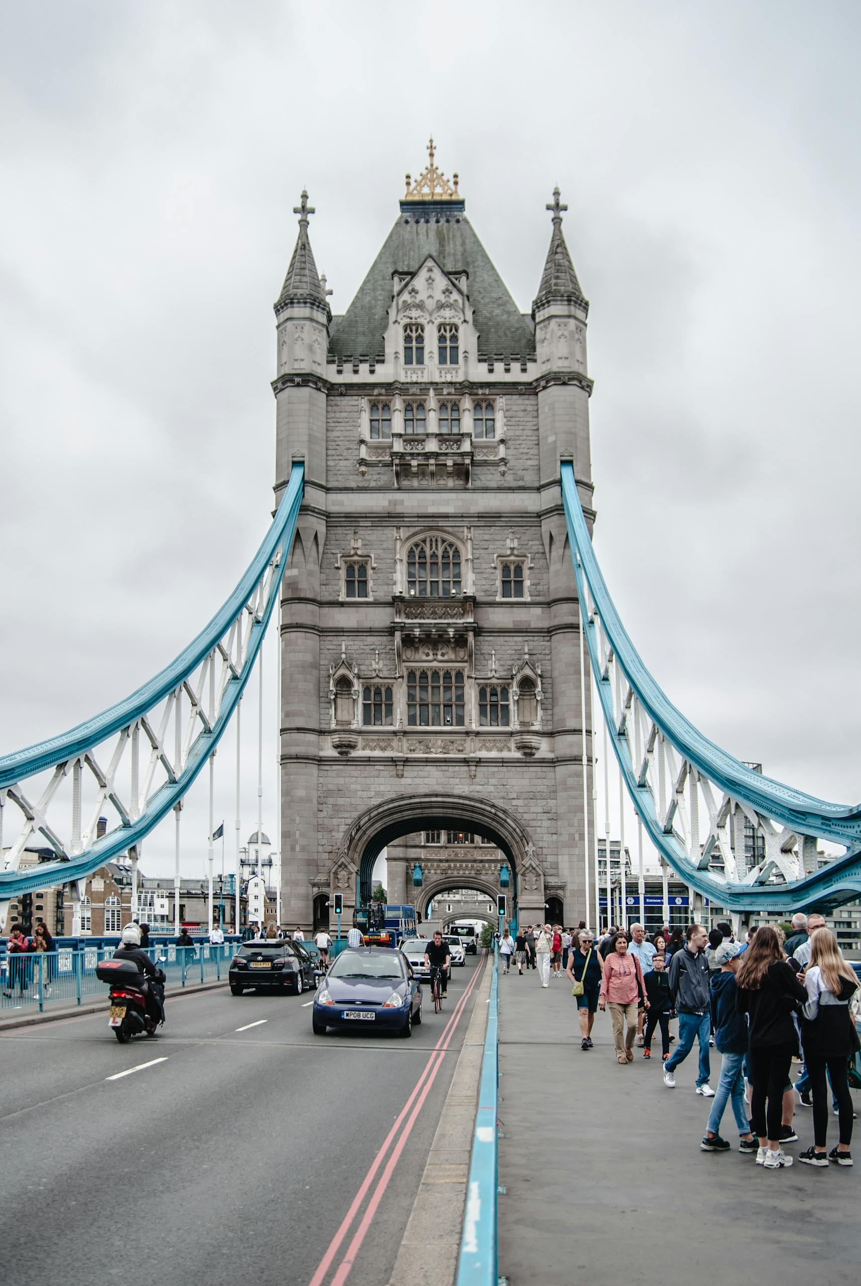 View of Tower Bridge in London, showcasing its iconic architecture and bustling scene with visitors.